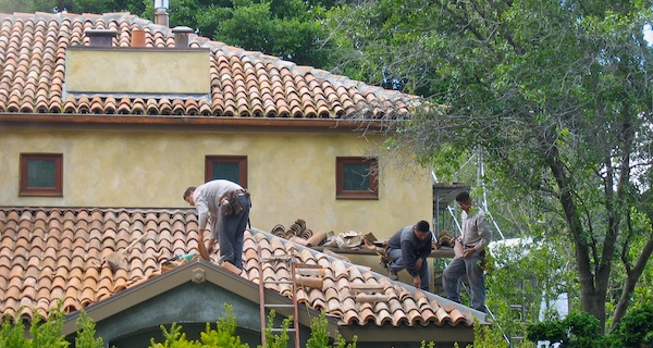 Izmirian roofing crew installing Spanish tile roof